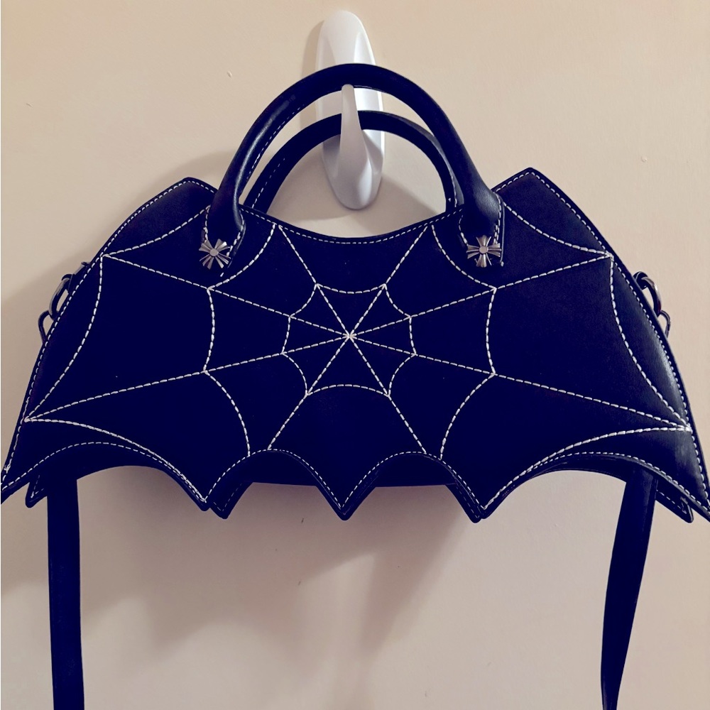Small bat shaped purse with cobweb stitching.